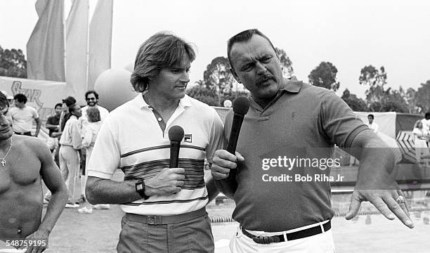 Beside the pool at the University California, Santa Barbara, American former professional athletes Bruce Jenner and Dick Butkus host a swimming event...