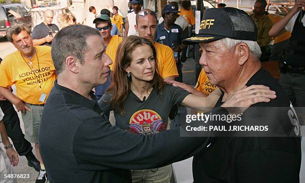 Metairie, UNITED STATES: US actor John Travola and actress wife Kelly Preston greet Jefferson Parish Sheriff Harry Lee at the department's Command...
