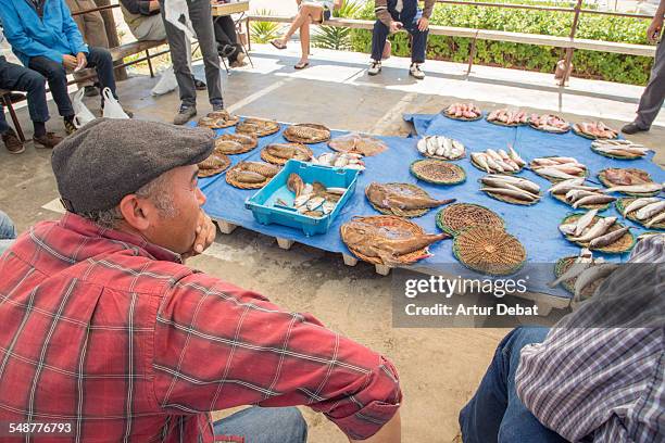 Fresh fish recently fished on the morning day for sale on auction in a traditional sung fish monger in the Barcelona shoreline. Mongat, Catalonia,...