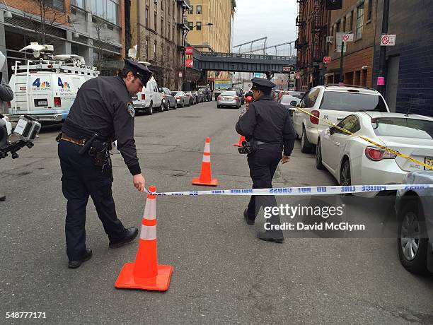 Cordoning off area with crime scene tape at scene of stabbing of Basketball Player Chris Copeland outside 1OAK club