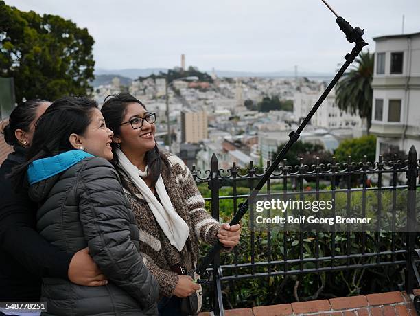 People using selfie stick at the lombard street in San Francisco