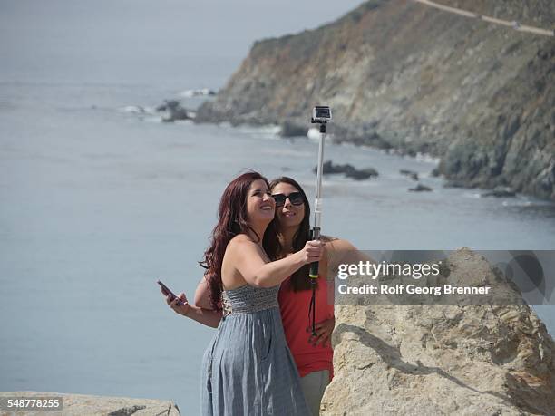 People using selfie stick at Big Sur in California