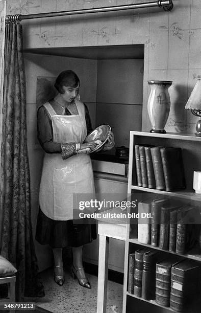 Germany Free State Prussia : Spinster in a private home, young woman in her kitchen alcove - 1929 - Photographer: Frankl - Published by: 'Berliner...