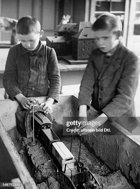 Germany Free State Prussia Berlin Berlin: State Institution for the Blind in Berlin-Steglitz, pupils fumbling a train in a sandbox - 1930 -...