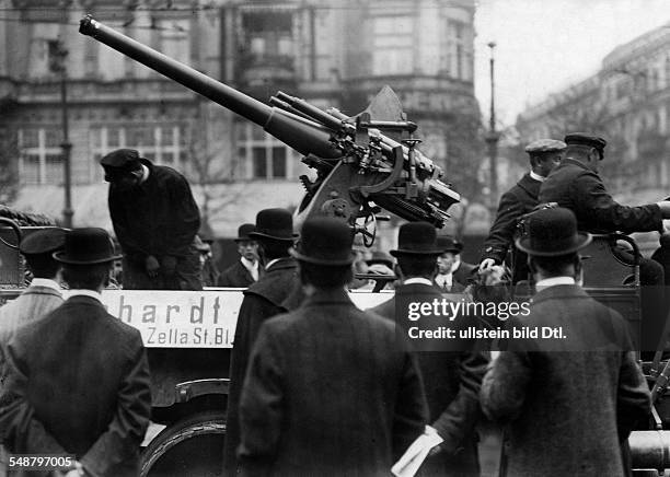 German Empire Kingdom Prussia Brandenburg Province Berlin Motor show in Berlin. Visitors look at a military vehicle with cannon. - Photographer:...