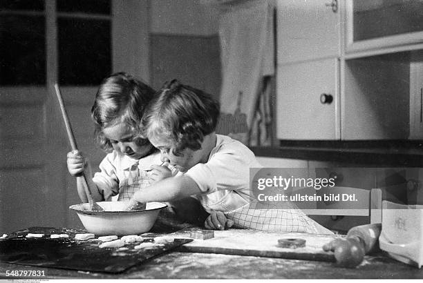 Children Two girls are baking cookies - 1932 - Photographer: Suse Byk - Published by: 'Das Blatt der Hausfrau' 5/1932 Vintage property of ullstein...