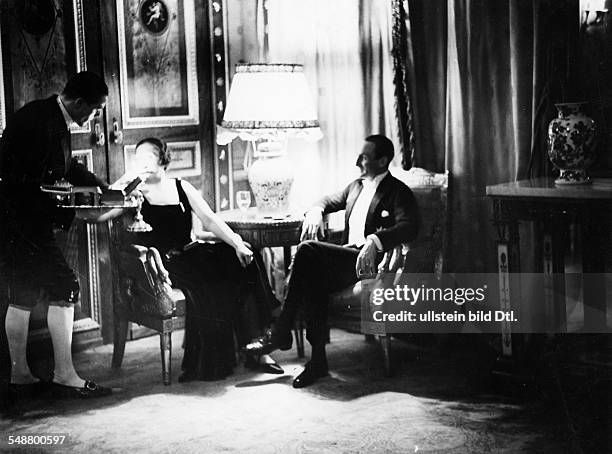 Evening reception in the German Embassy: Prince zu Schaumburg-Lippe sitting at a table with a woman Photographer: Ruth Blum about 1932 Vintage...