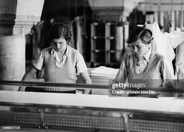 Germany : pupils of a South German school, girls ironing in the laundry - 1933 - Photographer: Kurt Huebschmann - Vintage property of ullstein bild
