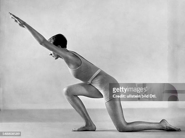Gymnastic exercise: kneeling down and swing forward with arms extended - Photographer: Fotografisches Atelier Ullstein - 1932 Vintage property of...