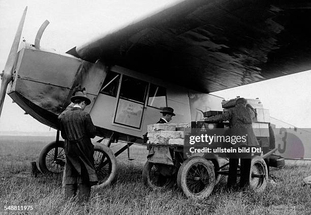 Baggage cart beside a Danish Air Lines Fokker F.III monoplane, 1924. Photographer: Frankl - Published by: 'Das Blatt der Hausfrau' 15/1924 Vintage...