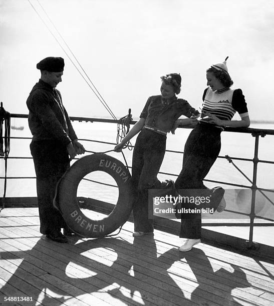 Fashion on deck of the ship 'Bremen Europe': Two ladies in dark blue trousers and blue-white-red striped sweaters - 1939 - Photographer: Karl Ludwig...