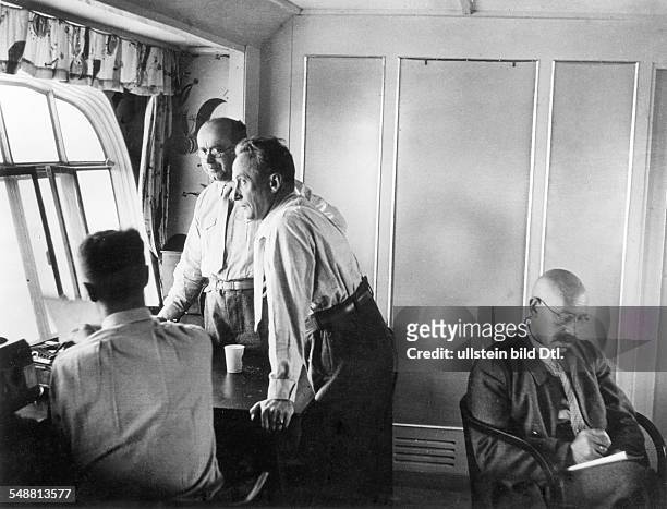 Polar flight of the LZ 127 'Graf Zeppelin': - Prof. Samoylowitsch, the scientific leader of the expedition, with his assistants at work during the...