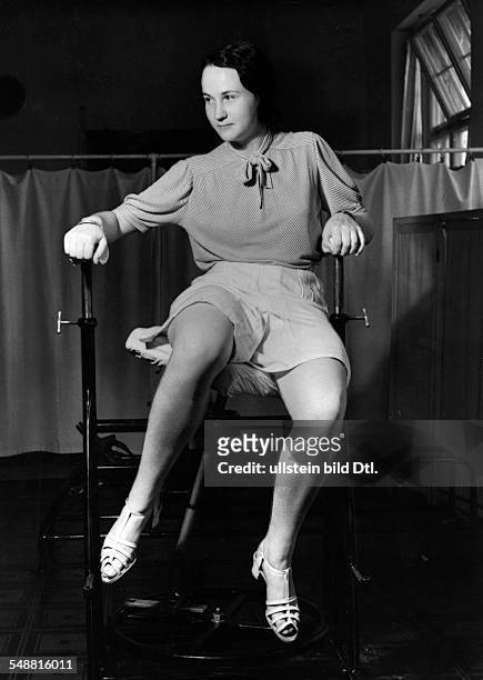 Young woman on a gym machine for slimming gymnastics - around 1938 - Photographer: Hedda Walther - Published by: 'Die Dame' 21/1938 Vintage property...
