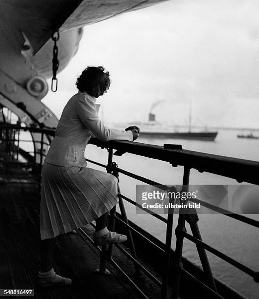 Fashion on deck of the 'Bremen Europe': woman in a white suit, pleated wool skirt and jacket - 1939 - Photographer: Karl Ludwig Haenchen - Published...