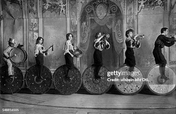 The artistic cycling group Klein at the Wintergarten in Berlin; the acrobats cycling on giant wheels and playing musical instruments - 1906 -...