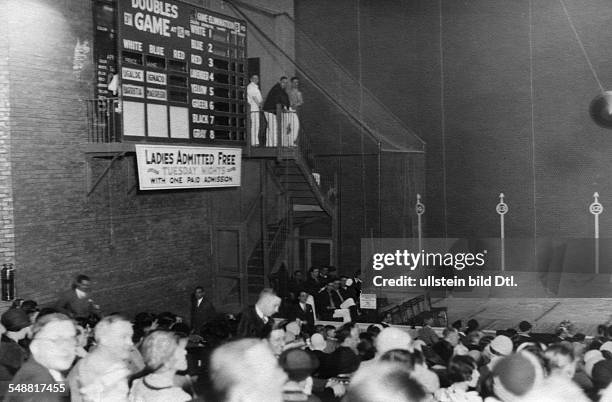 Illinois Chicago: Jai Ailai players in a hall. View of some of the players and the score board - 1929 - Photographer: James E. Abbe - Vintage...