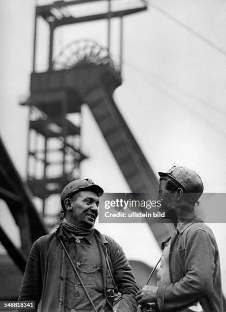 Federal Republic of Germany North Rhine-Westphalia : two miners in front of a shaft tower - 1955 - Photographer: Jochen Blume - Vintage property of...