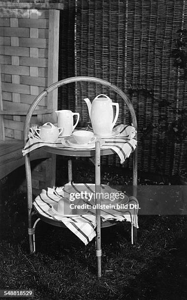 Lapsible table - opened with a tablecloth and coffee service - Photographer: Fotografisches Atelier Ullstein - Published by: 'Die Dame' 24/1931...