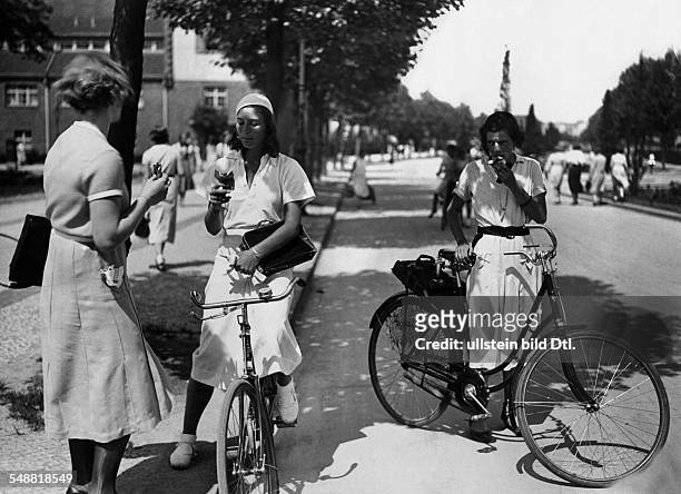 School girls eating ice cream on bikes - undated - Photographer: Seidenstuecker - Published by: 'Uhu' 1/1932 Vintage property of ullstein bild