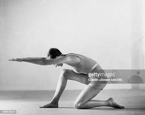 Gymnastic exercise: kneeling down and swing forward with arms extended - Photographer: Fotografisches Atelier Ullstein - 1932 Vintage property of...
