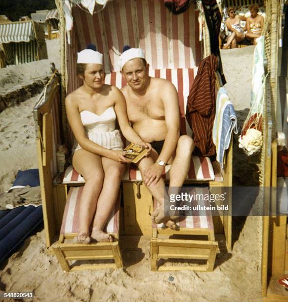 Couple sitting in a wicker beach chair, on a beach near Cuxhaven, North Sea