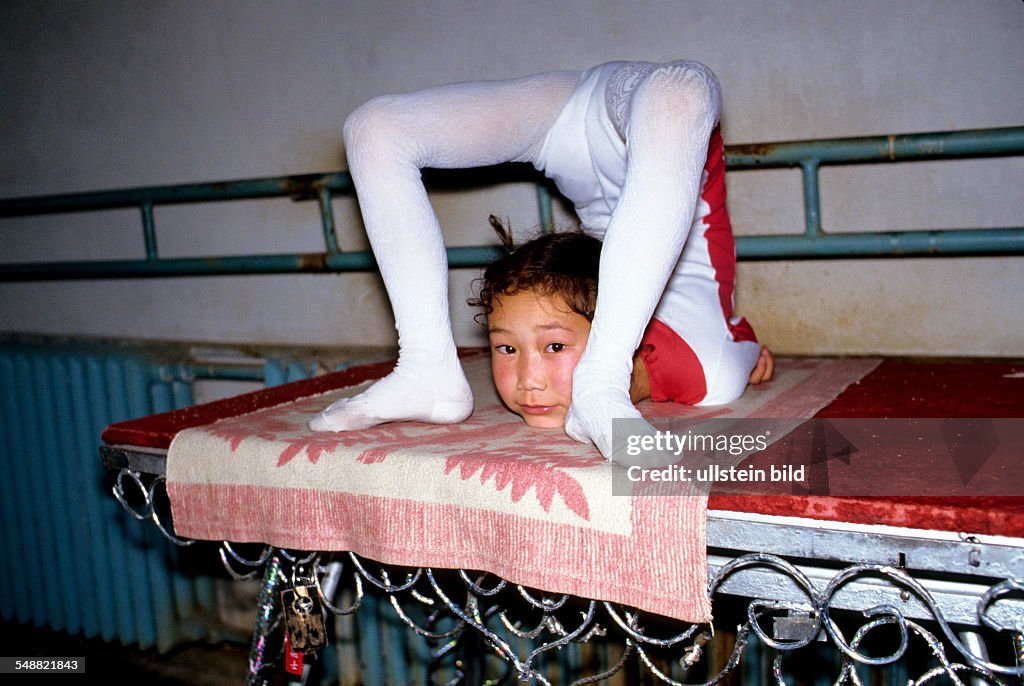 MNG, Mongolia, the famous snake girls of the Mongolian state circus training in Ulaanbaatar.