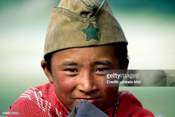 Mongolia, a young boy with a military cap in the Khoevsgoel province.