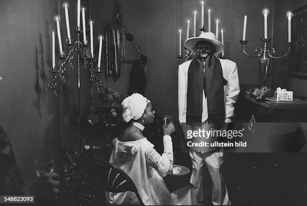 United States of America, North Carolina, Raleigh: Wedding with a voodoo spirit. The bride is drinking a glass of champagne with her new husband...