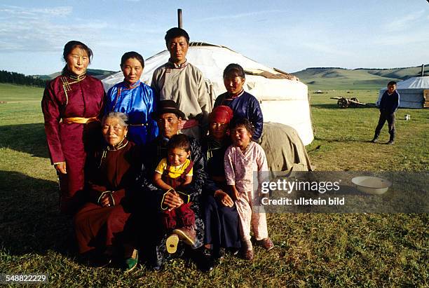 Mongolia, a family in traditional clothes in front of their Jurts in the Khoevsgoel province.