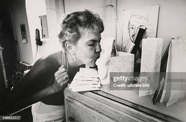 Florida, Miami: Gay kisses a Buddha in a room at the Madrid Hotel.