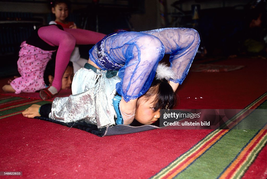 MNG, Mongolia, the famous snake girls of the Mongolian state circus training in Ulaanbaatar.