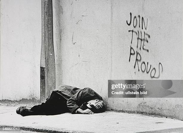 Northern Ireland, Londonderry: A drunk man sleeps on the pavement.