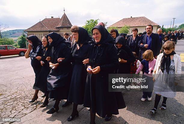 Romania: An ortodox burial in Transylvania. The funeral procession.