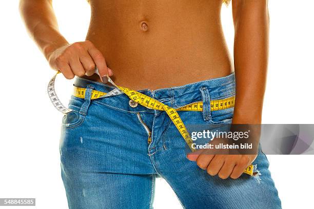 Symbolic photo diet, woman wearing jeans with measuring tape