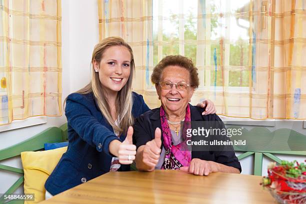 Granddaughter and grandmother, young woman and elder woman -