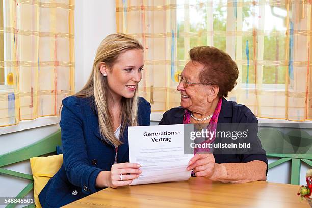 Granddaughter and grandmother with contract of the generations -