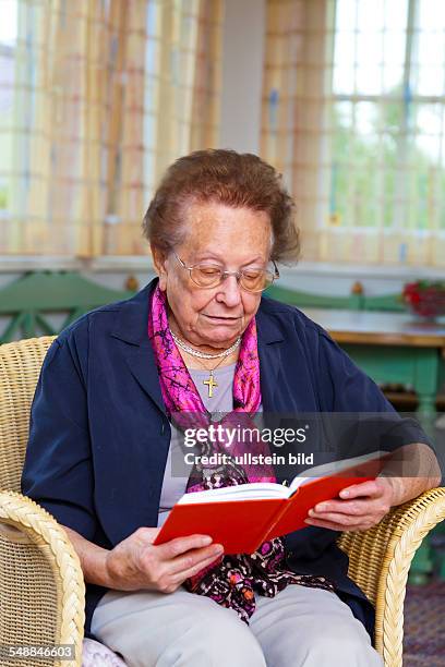 Elder lady is reading a book -