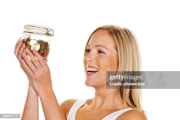 Symbolic photo saving money, woman looking at a savings box -