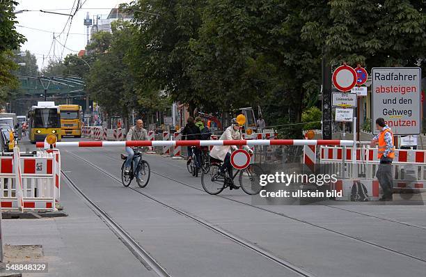 Germany Berlin Prenzlauer Berg - closing of the road Kastanienallee because of road construction, barrier with guard to keep bikers off -