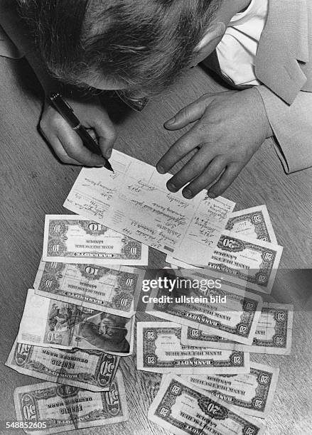 Germany - man is filling in paying-in slip - 1950s