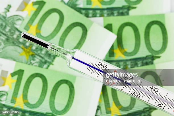 Symbolic photo crisis of the Euro currency, 100 Euro banknotes and clinical thermometer