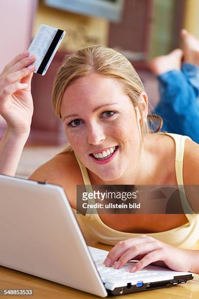 Woman with laptop and credit card is shopping online -