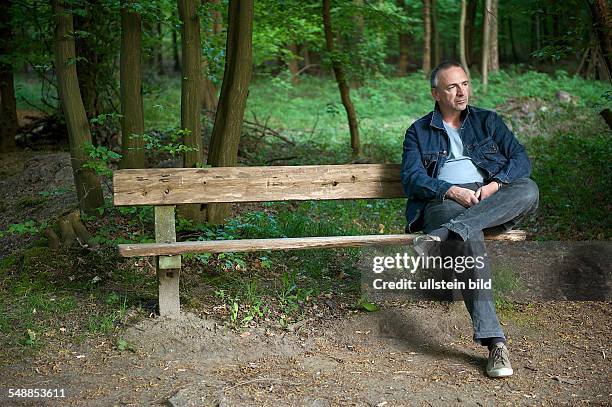 Germany Hamburg - man sitting on a bench in the Niendorf Gehege -