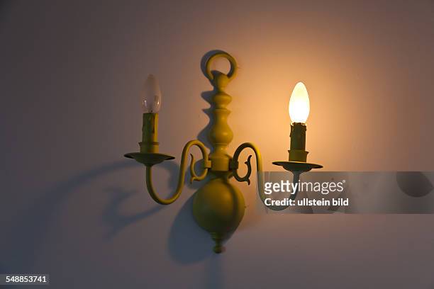 Lamp in a room, one light bulb is out of order