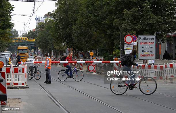 Germany Berlin Prenzlauer Berg - closing of the road Kastanienallee because of road construction, barrier with guard to keep bikers off -