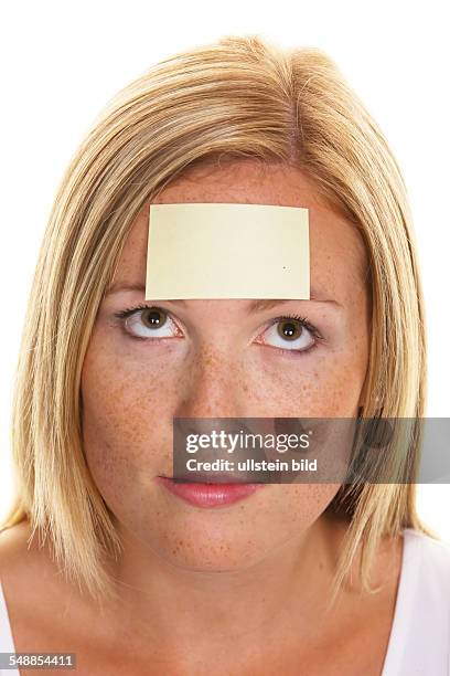 Woman with a notepad on her forehead -