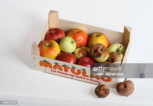 Symbolic photo, rotten apples among good fruits in a fruit crate with label Euro Zone