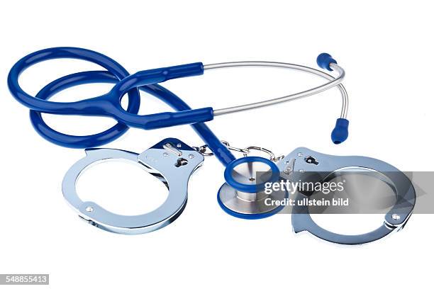 Symbolic photo fraudulent invoicing, handcuffs and stethoscope