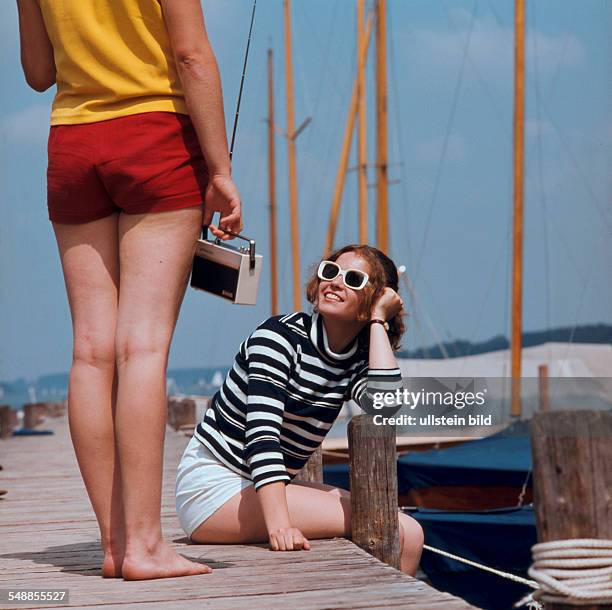 Women on a pier in a marina - 1970s