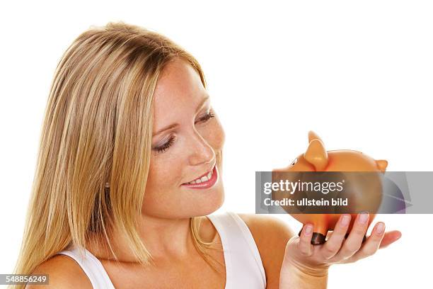 Symbolic photo saving money, woman with piggy bank -